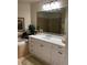 Elegant bathroom with vanity, granite countertop, large mirror, and tiled tub surround at 96 Vivante Blvd # 9622, Punta Gorda, FL 33950