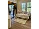 Cozy bedroom featuring a daybed, a floral rug, and views of the outdoors through a sliding glass door at 96 Vivante Blvd # 9622, Punta Gorda, FL 33950
