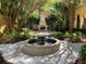 Beautiful courtyard with fountain, fireplace, garden, shade trees, and seating area for quiet contemplation at 96 Vivante Blvd # 9622, Punta Gorda, FL 33950