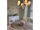 Cozy dining area features wooden table, chandelier, and accent plates on wall at 96 Vivante Blvd # 9622, Punta Gorda, FL 33950