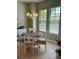 Cozy dining area with a charming chandelier, surrounded by soft green walls and bright windows at 96 Vivante Blvd # 9622, Punta Gorda, FL 33950