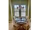 Quaint dining area with a round table and four chairs, illuminated by a decorative chandelier and natural light at 96 Vivante Blvd # 9622, Punta Gorda, FL 33950