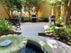 Grilling area featuring multiple grills, a fountain, and landscaping, ideal for outdoor cooking and entertaining at 96 Vivante Blvd # 9622, Punta Gorda, FL 33950