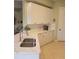 White kitchen with quartz countertop and stainless sink at 96 Vivante Blvd # 9622, Punta Gorda, FL 33950