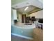 Modern kitchen featuring white cabinets, a breakfast bar, black appliances, and a built-in desk area at 96 Vivante Blvd # 9622, Punta Gorda, FL 33950