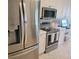 This eat-in kitchen features new stainless steel appliances and stylish white cabinets at 96 Vivante Blvd # 9622, Punta Gorda, FL 33950