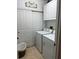 Well-lit laundry room with a washer and dryer, sliding closet doors, and overhead cabinets at 96 Vivante Blvd # 9622, Punta Gorda, FL 33950