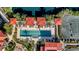 Aerial view of rectangular pool with red-roofed cabanas and tennis court, perfect for relaxation and recreation at 96 Vivante Blvd # 9622, Punta Gorda, FL 33950