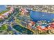 A captivating aerial view of the beautiful community showcasing lush landscaping, tennis courts, a pool, and waterfront residences at 99 Vivante Blvd # 310, Punta Gorda, FL 33950