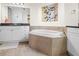 Bathroom featuring a soaking tub with tile surround and vanity with dark countertops at 99 Vivante Blvd # 310, Punta Gorda, FL 33950