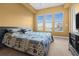 Bedroom with neutral walls, carpet floors, large window, and decorative bedding at 99 Vivante Blvd # 310, Punta Gorda, FL 33950