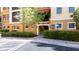 Welcoming entrance with manicured landscaping to a beautiful yellow condo building with stairs and balconies at 99 Vivante Blvd # 310, Punta Gorda, FL 33950