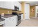 Modern kitchen with stainless steel appliances, white cabinets, and updated countertops at 99 Vivante Blvd # 310, Punta Gorda, FL 33950