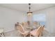 Dining area with water view, features a glass table, wicker chairs and pendant lighting at 1 Colony Point Dr # B20, Punta Gorda, FL 33950