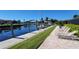 Picturesque waterfront view with private boat dock, lounge chairs, and lush landscaping at 1 Colony Point Dr # B20, Punta Gorda, FL 33950