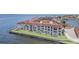 Waterfront condo building with a red tile roof and large windows overlooking the water at 1 Colony Point Dr # B20, Punta Gorda, FL 33950