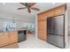 Bright kitchen featuring wooden cabinets, stainless steel refrigerator, and a view to the dining area at 1 Colony Point Dr # B20, Punta Gorda, FL 33950