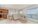 Bright living room with neutral tones, water views, and a combined dining space at 1 Colony Point Dr # B20, Punta Gorda, FL 33950