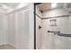 Shower with tile surround, grab bars, and tiled accent. Bi-fold doors to linen closet at 1 Colony Point Dr # B20, Punta Gorda, FL 33950
