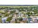 Expansive aerial view of a residential community with many homes, surrounded by lush trees and greenery at 1210 Mccrory St, North Port, FL 34286