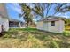 Landscaped backyard with storage shed and screened-in porch at 1210 Mccrory St, North Port, FL 34286