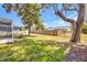 Large backyard has mature trees and a wooden fence at 1210 Mccrory St, North Port, FL 34286
