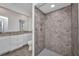 Updated bathroom with marble countertop vanity, toilet, walk-in shower with patterned tile and shower caddy at 1210 Mccrory St, North Port, FL 34286