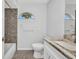 Neutral bathroom features updated vanity with granite counters, and a decorative half-moon window at 1210 Mccrory St, North Port, FL 34286