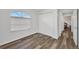 Bedroom with wood floors, a large window with blinds, and a closet with sliding doors at 1210 Mccrory St, North Port, FL 34286