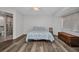 Bedroom with wood floors, a ceiling fan, ensuite bathroom access, and a window letting in natural light at 1210 Mccrory St, North Port, FL 34286