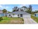 Well-maintained single-story home featuring a screened entry and attached two-car garage at 1210 Mccrory St, North Port, FL 34286