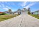 Charming single-story home with a long driveway and well-manicured lawn at 1210 Mccrory St, North Port, FL 34286