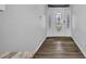 Bright, open foyer with wood-look flooring and a decorative front door at 1210 Mccrory St, North Port, FL 34286