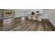 Large, open living area featuring luxury vinyl plank flooring and a connected kitchen at 1210 Mccrory St, North Port, FL 34286