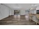 Open-concept living space with wood-look flooring and access to the screened lanai at 1210 Mccrory St, North Port, FL 34286