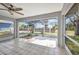 Relaxing enclosed patio with tile flooring, fan, and a view of the yard at 1210 Mccrory St, North Port, FL 34286