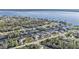 Stunning aerial view of waterfront homes along canal leading to bay with lush greenery and docks at 12299 Albrecht Ter, Port Charlotte, FL 33981
