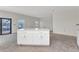 Spacious kitchen featuring an island with white cabinets and light countertops in a new construction home at 12299 Albrecht Ter, Port Charlotte, FL 33981