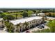 Aerial view of the property showcasing well-maintained buildings, lush landscaping, and ample parking at 1236 Rio De Janeiro Ave # 406, Punta Gorda, FL 33983