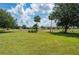 Lush green backyard with mature trees and landscaping, offering a serene outdoor space at 1236 Rio De Janeiro Ave # 406, Punta Gorda, FL 33983