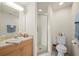 Modern bathroom with vanity, framed mirror, and tiled shower with glass door at 1236 Rio De Janeiro Ave # 406, Punta Gorda, FL 33983