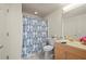 Bright bathroom featuring a vanity with wood cabinets and a shower with patterned curtain at 1236 Rio De Janeiro Ave # 406, Punta Gorda, FL 33983