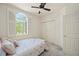 Bright bedroom featuring a window with shutters and double door closet at 1236 Rio De Janeiro Ave # 406, Punta Gorda, FL 33983