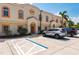 Attractive building exterior featuring multiple units, designated parking and tropical landscaping at 1236 Rio De Janeiro Ave # 406, Punta Gorda, FL 33983