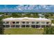 Exterior view of a charming condo building, featuring screened lanais and meticulously manicured grounds at 1236 Rio De Janeiro Ave # 406, Punta Gorda, FL 33983