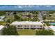 Exterior view of a lovely two-story condo building with screen patios and well-kept landscaping at 1236 Rio De Janeiro Ave # 406, Punta Gorda, FL 33983
