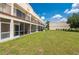 Exterior of building featuring a spacious lawn and patios enclosed with screens at 1236 Rio De Janeiro Ave # 406, Punta Gorda, FL 33983