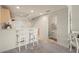 Modern kitchen featuring a breakfast bar with seating and access to a half bathroom at 1236 Rio De Janeiro Ave # 406, Punta Gorda, FL 33983