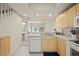 Open-concept kitchen showcasing stainless steel sink, modern appliances, and an easy-access to a bathroom at 1236 Rio De Janeiro Ave # 406, Punta Gorda, FL 33983
