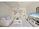 Comfortable living room featuring a ceiling fan, modern decor, and an open layout to the dining area and kitchen at 1236 Rio De Janeiro Ave # 406, Punta Gorda, FL 33983
